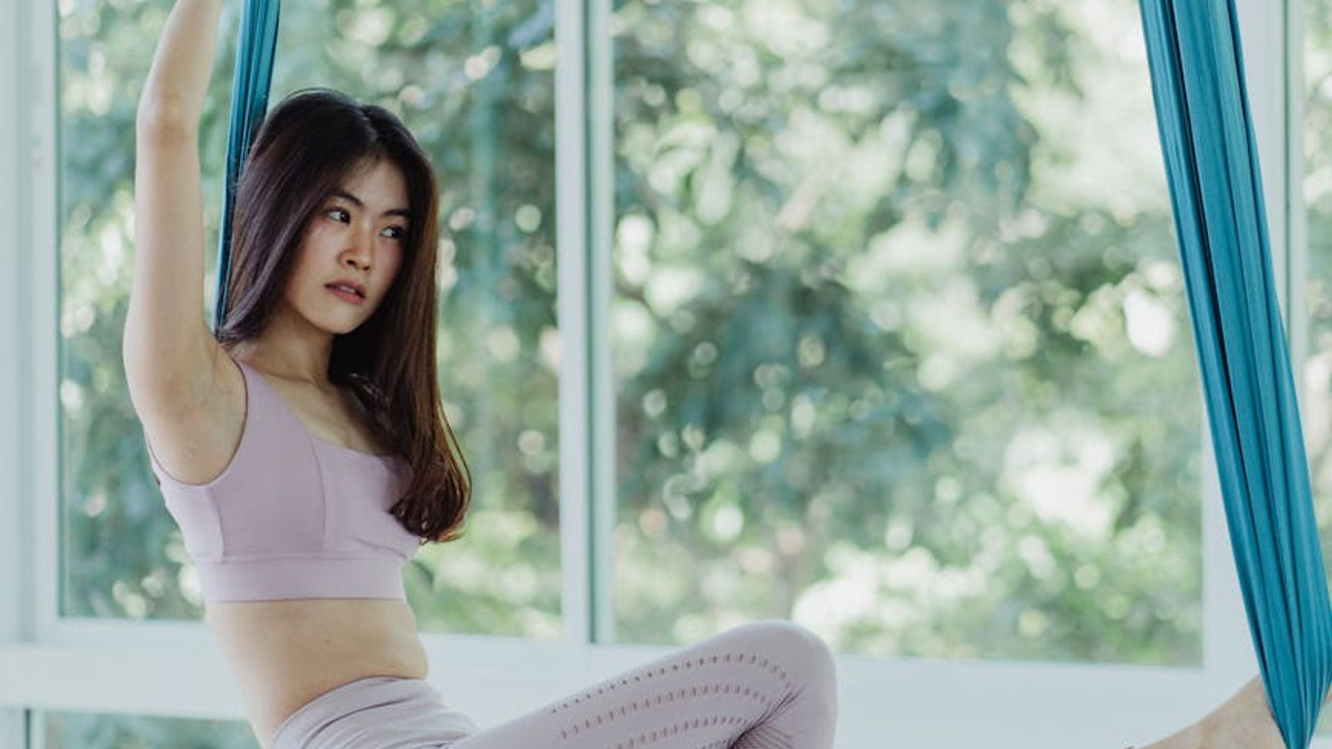 Serene person practicing yoga in a bright studio with soft light